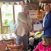 Terry Pearce eceiving his volunteer of the year award from Bluebird Community Transport chief executive Matt Roberts at an afternoon tea in Burgess Hill SUS-210913-144019001