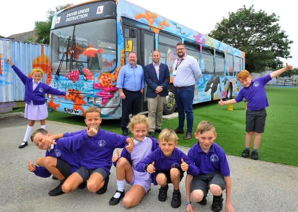 Brighton & Hove Bus Company has donated a single decker bus for Shoreham Beach Primary School.  Headteacher Darren Vallier with parent Chris Mclelland and Adrian Strange, from the bus company. Pic S Robards SR2109091