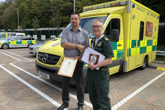 David receiving his retirement gifts from James Pavey (head of production and workforce planing at SECAmb) SUS-210915-095323001