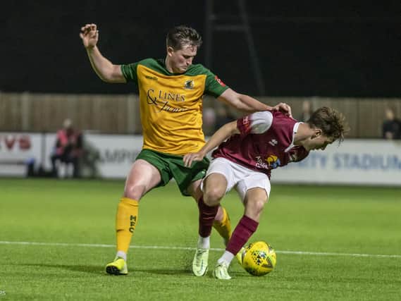 Charlie Harris does battle for Horsham in Tuesday's derby with Bognor Regis Town. Pictures by Lyn Phillips