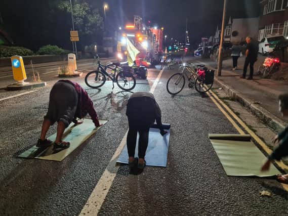 Activists and parents performed yoga exercises in the road to prevent the cycle lane markings being removed