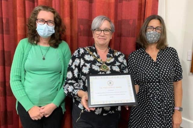 Angmering Parish Council chair Nikki Hamilton-Street, centre, presents the award for Angmering Medical Centre staff and Covid vaccination centre volunteers
