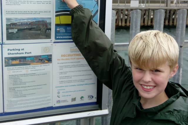 Jamie Hewitt from Horsham with his litter poster at Shoreham Port SUS-210921-113445001