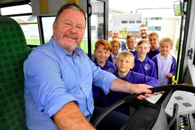 Head teacher Darren Vallier with pupils on the bus