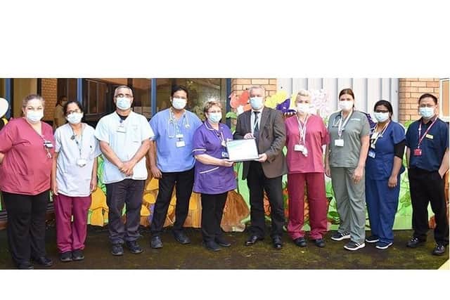 Chairman Steve Phoenix with Matron Liz Vaughan and the paediatric team. Photo from East Sussex Healthcare NHS Trust. SUS-210923-120732001