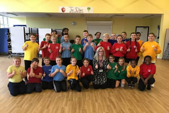 Principal Sarah Dunne with the pupils in their PE kits