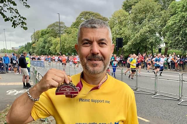 James Baydar celebrates completing the Great North Run, his 21st half marathon in 2021 for the Worthing and District branch of Cats Protection
