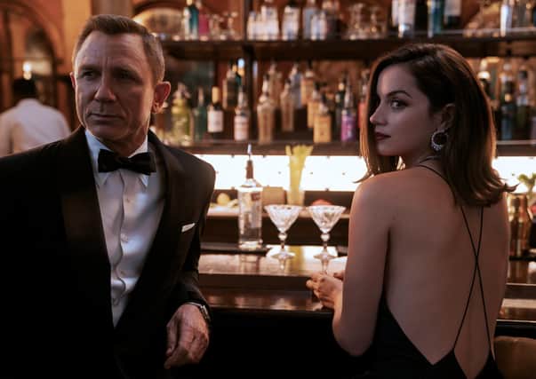 Daniel Craig as James Bond and Ana de Armas as Paloma.
