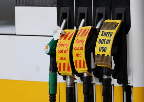 'Out of Use' signage is pictured on the petrol pumps (Photo by ADRIAN DENNIS/AFP via Getty Images)