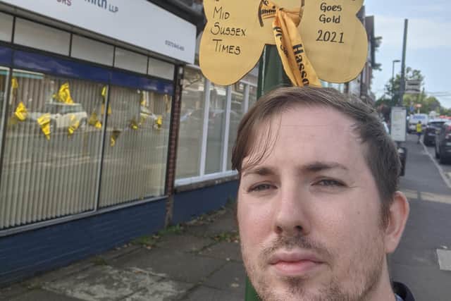 Mid Sussex Times political editor Joshua Powling next to the Middy's giant Hassocks Goes Gold ribbon.