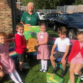 Alison Whitburn, community champion at Littlehampton Morrisons, delivering a harvest wheatsheaf and toys to Arundel Church of England School