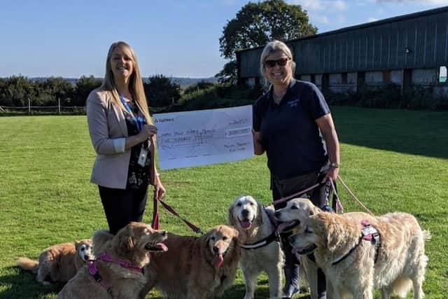 Happy Paws Puppy Rescue in Eastbourne with the £500 cheque from police. Picture from Sussex Police SUS-210510-153721001