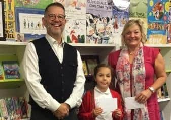 Schoolsworks chief executive Chris Seaton with Emma Purkis, acting head teacher at Edward Bryant School, and summer reading champion Ella
