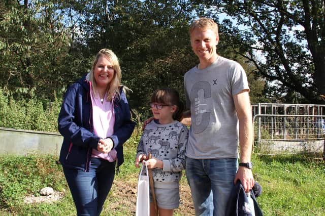 Mid Sussex MP Mims Davies with organic dairy farmer Dan Burdett and his daughter Molly. Picture: Fairer World Lindfield.