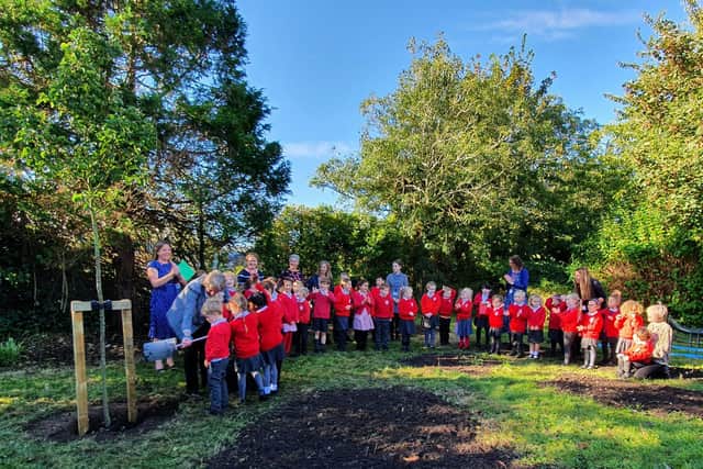 The Pupils of Rumboldswhyke Primary School with the commemorative tree
