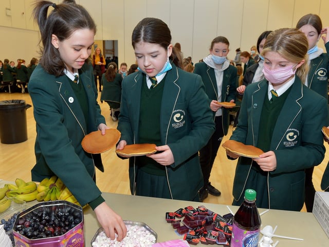 St Cecilia’s College Year 8 pupils choose toppings for their pancake breakfast at the school on Tuesday morning last. DER2209GS – 018