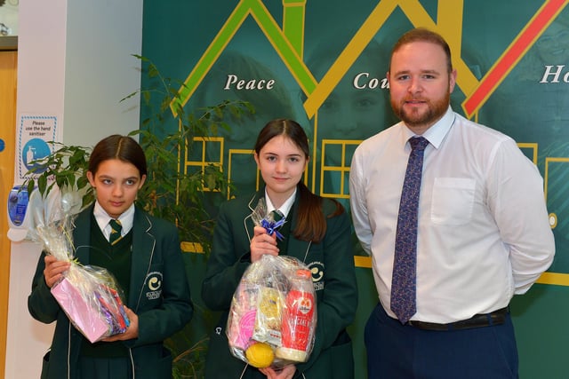 Chantelle Smith and Ava Rhodes Year 9 pupils at St Cecilia’s College pictured with Year Head Mr Christopher McMenamin and their prizes from a draw held during a pancake breakfast at the school on Tuesday morning last. DER2209GS – 022