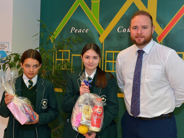 Chantelle Smith and Ava Rhodes Year 9 pupils at St Cecilia’s College pictured with Year Head Mr Christopher McMenamin and their prizes from a draw held during a pancake breakfast at the school on Tuesday morning last. DER2209GS – 022