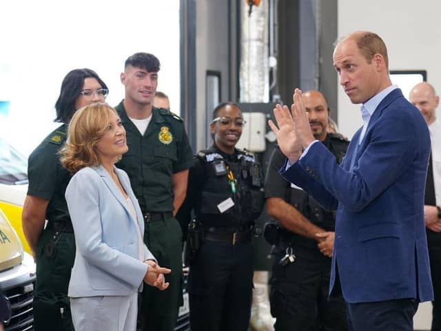 Prince William, Prince of Wales (R), with Dr Sian Williams (L), talking to staff during a visit for a previous mental health week.