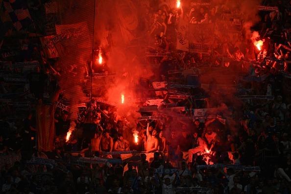 Marseille's fans light flares during the UEFA Europa League Group B first leg football match between Olympique de Marseille (OM) and Brighton and Hove Albion at the Stade Velodrome