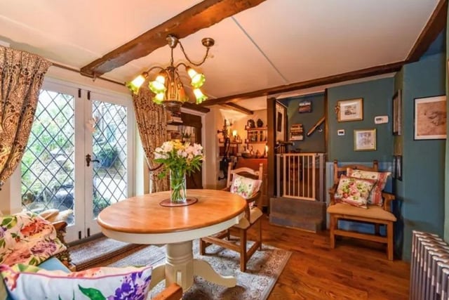 The adjacent dining room has double doors to the garden, access to the kitchen and stairs to the first floor. This room also has exposed beams, Oak flooring and a step up to the pretty cloakroom with leaded stained glass door and tiled floor.