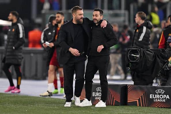 Daniele De Rossi, Head Coach of AS Roma, embraces Roberto De Zerbi, Manager of Brighton & Hove Albion, at full-time in Rome