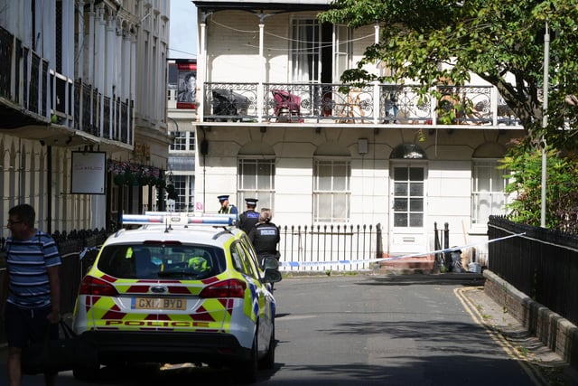 Emergency services were called to a Brighton housing development after a man fell through a third-floor window.
