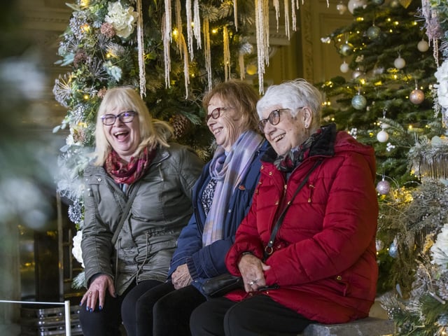Photo opportunity under the colourful archway in the enchanted winter garden in the Marble Hall at Petworth, West Sussex