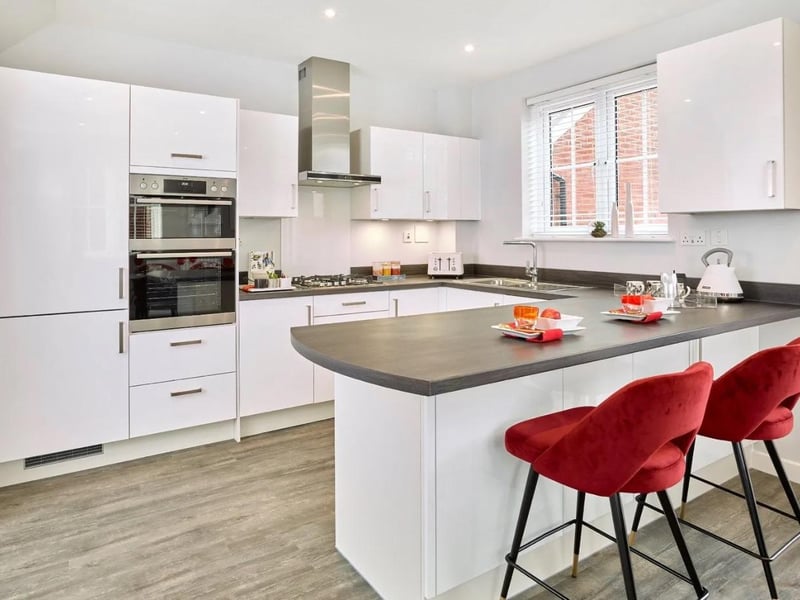 The kitchen is fitted with gloss finish Paula Rosa Manhattan units with quartz worktops and integrated appliances