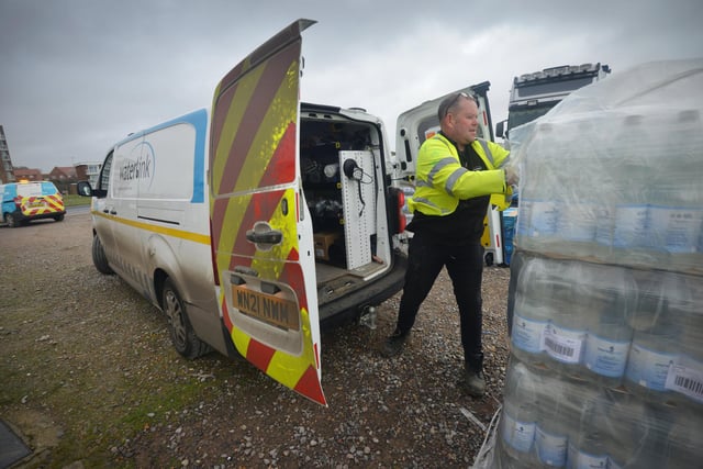 South East Water handing out bottles of water to residents outside Bexhill Sea Angling Club after Storm Eunice caused a lack of power to water pumping stations.