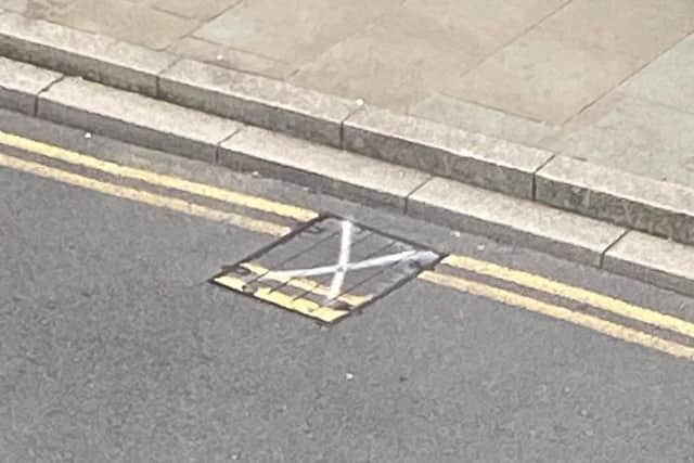 A local resident notified East Sussex County Council of the manhole cover on the town’s high street which was ‘out of line’ and sprayed a cross on the cover so it could easily be identified.