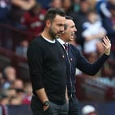 Brighton's Italian head coach Roberto De Zerbi (L) watches on as his team after thrashed in the Premier League at Aston Villa