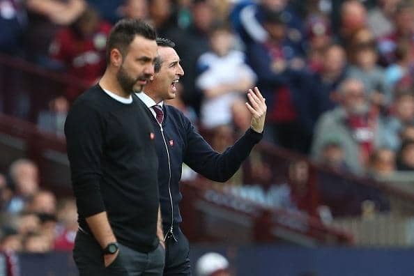 Brighton's Italian head coach Roberto De Zerbi (L) watches on as his team after thrashed in the Premier League at Aston Villa