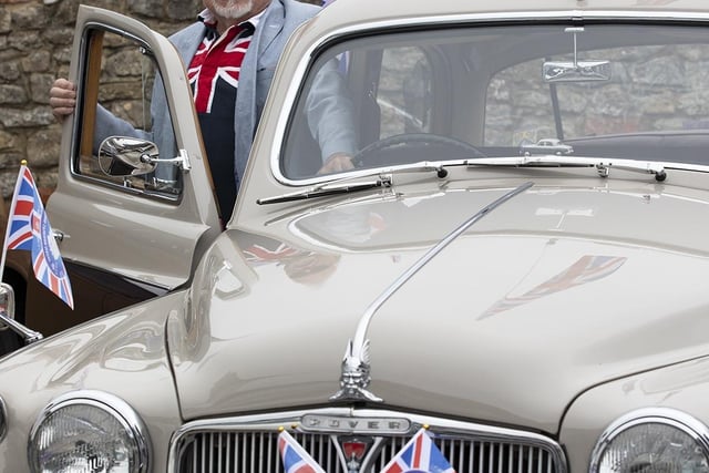 Member Trevor Rawlings of the Manhood Classic Cars with his 1963 Rover 95 decked in Union  in Selsey High Street 