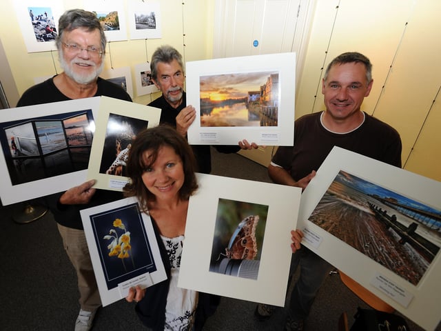 Members of Littleampton Camera Club with some of their work for the 2009 annual exhibition, ahead of the 65th anniversary season