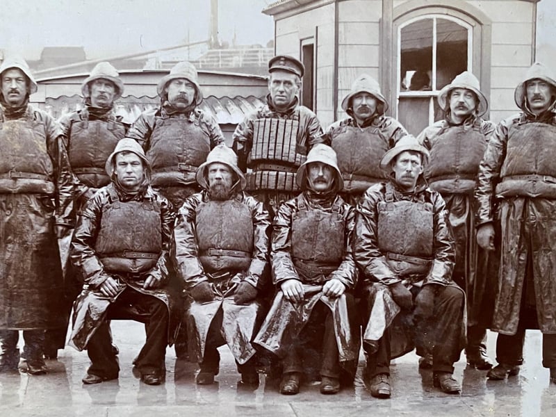 Crew of the ‘Michael Henry IV’ in 1910, as above, taken at the back of what used to be the Harbour Master’s Boathouse.