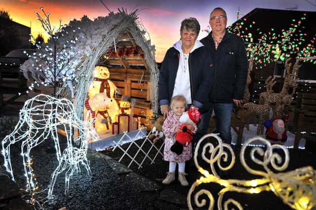 Sallyanne and Grahame King and their granddaughter Marlo Kingsley at the twinkling Christmas display at their home in Cottingham Avenue, Horsham. Pic S Robards SR2212021