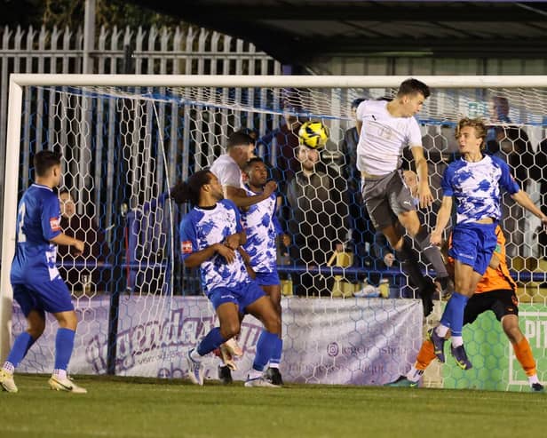 Tom Chalmers scores one of Hastings' four goals at Wingate and Finchley | Picture: Scott White