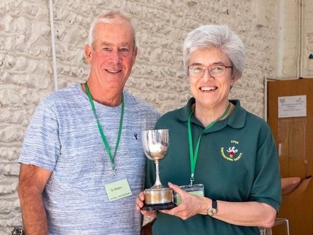 Diana Buckley receives the Cookery Goblet for most points in cookery from chairman Chris Hill