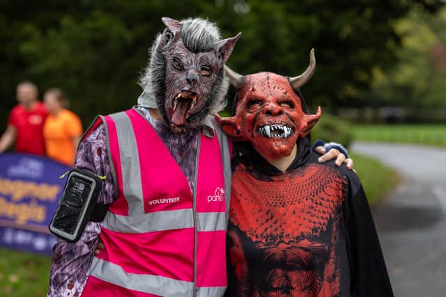 A Parkrun volunteer and runner pose in their costumes. Photo: Neil Cooper