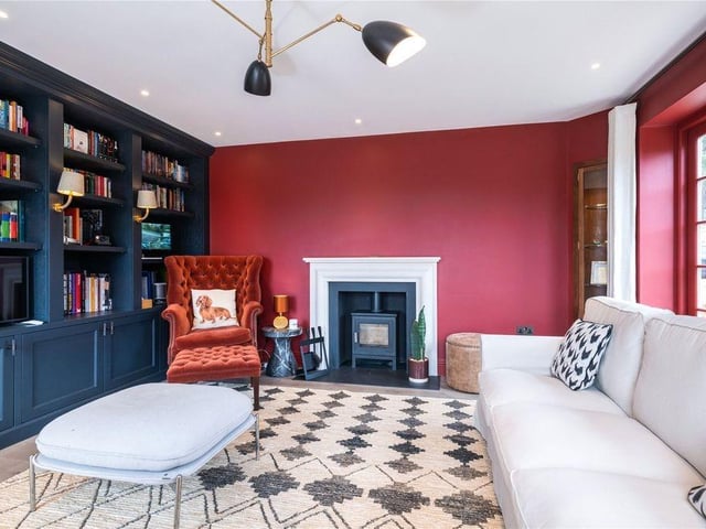 The sitting room has a Chesney wood burner and full height fitted, bespoke bookshelves