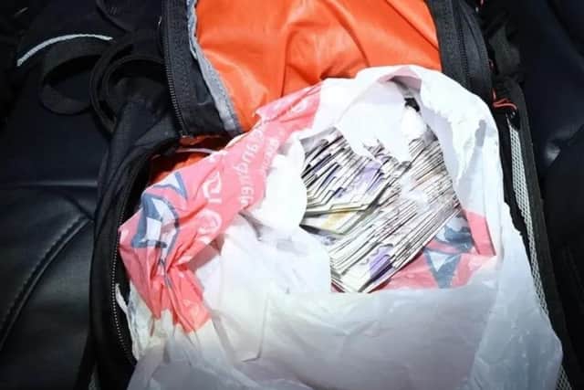 Counter terrorism officer seized a bag of money. Photo: COUNTER TERRORISM POLICING SOUTH EAST