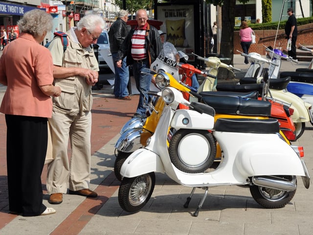 Taking a keen interest in the scooters on show in South Street Square