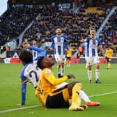 Referee Graham Scott shows the red card to Nelson Semedo of Wolverhampton Wanderers after tackling Kaoru Mitoma of Brighton & Hove Albion during the Premier League match