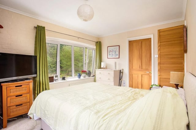 The property has a double-aspect principal bedroom with an en suite bathroom, a second double bedroom with fitted storage, a smaller bedroom and a family bathroom