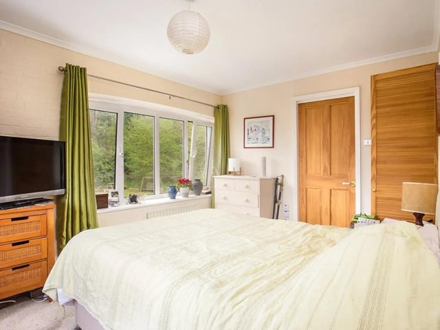 The property has a double-aspect principal bedroom with an en suite bathroom, a second double bedroom with fitted storage, a smaller bedroom and a family bathroom