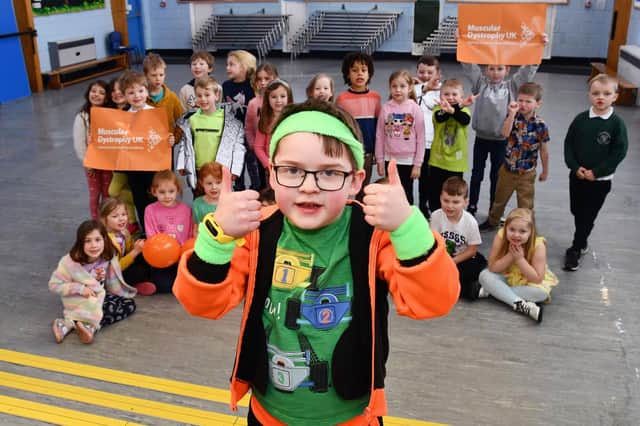 Six-year-old Jack Robinson gives his schoolmates the thumbs up for supporting Muscular Dystrophy UK's Go Bright fundraising day
