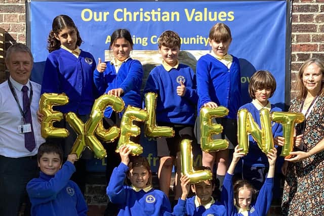 Pupils and staff at Christ Church Primary celebrate the school's 'Excellent' rating.