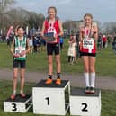 Hy's Isabella Buchanan tops the podium after winning the girls' U13 title at the South of England cross country championships