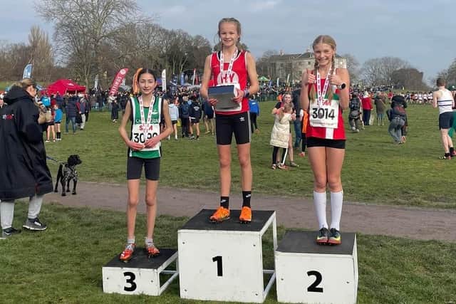 Hy's Isabella Buchanan tops the podium after winning the girls' U13 title at the South of England cross country championships